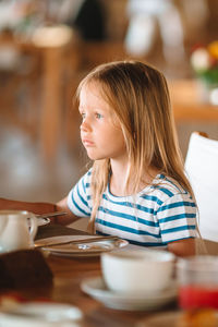 Cute girl sitting at restaurant