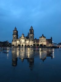 Reflection of building in water at dusk