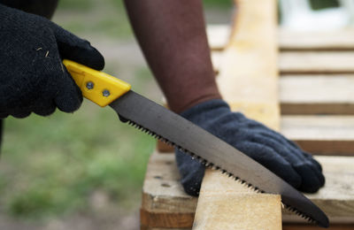 Close-up of man working on wood