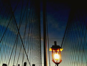 Low angle view of illuminated street light against blue sky