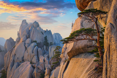 Rock formations on mountain against sky during sunset