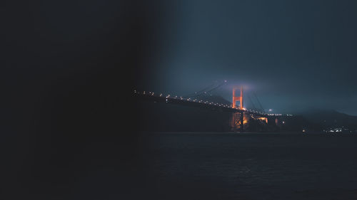 Illuminated suspension bridge at night