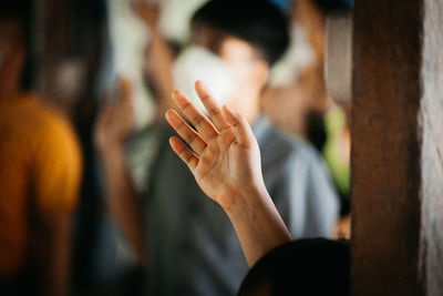 Close-up of hand on cross