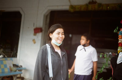 Portrait of smiling young couple standing outdoors