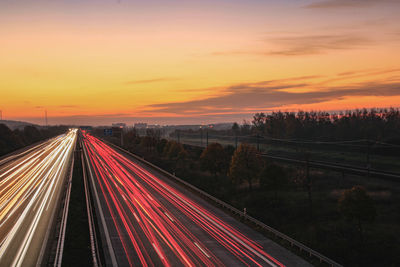 High angle view of light trails on highway during sunset