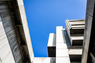 Low angle view of buildings against clear blue sky