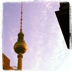 Low angle view of communications tower against sky