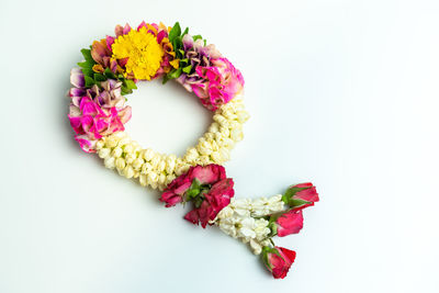 Close-up of pink flower bouquet against white background