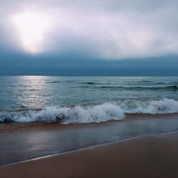 Scenic view of sea against cloudy sky