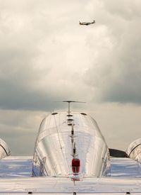 Low angle view of airplanes against sky