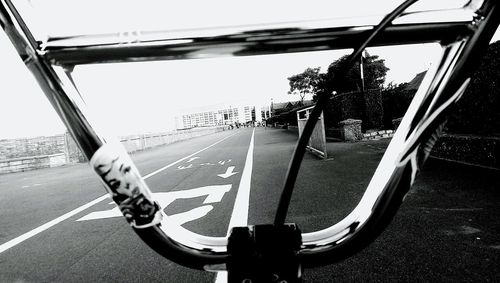 Close-up of bicycle on road against sky