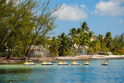 Jet skis in caribbean ocean against sky on a sunny day