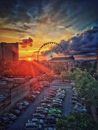 View of ferris wheel in city against sky