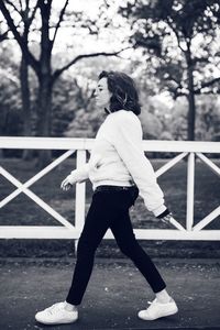 Rear view of young woman standing in park