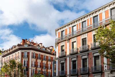 Old luxury residential buildings with balconies in serrano street in salamanca district in madrid.