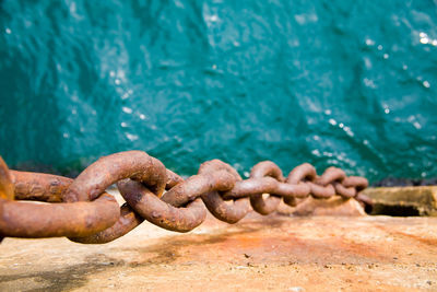 Close-up of rusty chain in sea