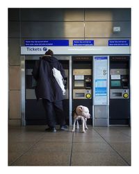 Rear view of man standing at subway station