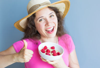 Portrait of smiling woman holding ice cream