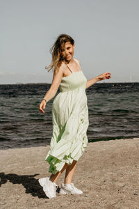 Young woman standing at beach