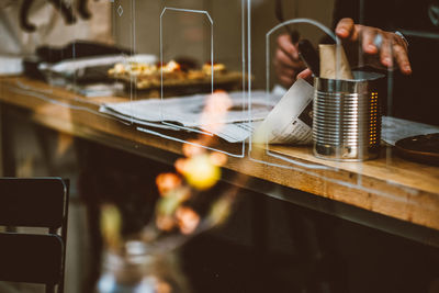 Reflection of people on table at restaurant