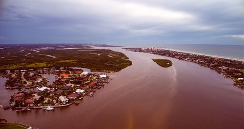 Aerial view of sea against cloudy sky