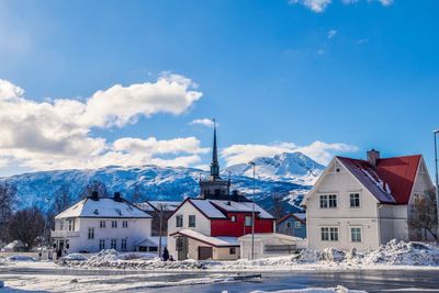 Houses in city against sky