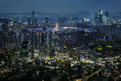 High angle view of illuminated city buildings at night