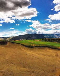 Scenic view of landscape against cloudy sky