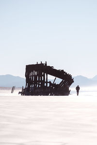 View of abandoned truck on field against clear sky