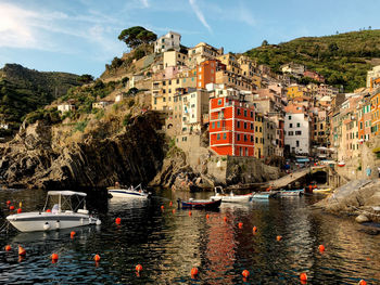 Buildings by sea against sky in city