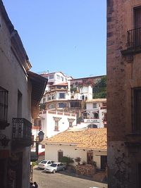 Buildings in town against blue sky