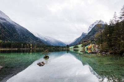 Scenic view of lake and mountains against sky