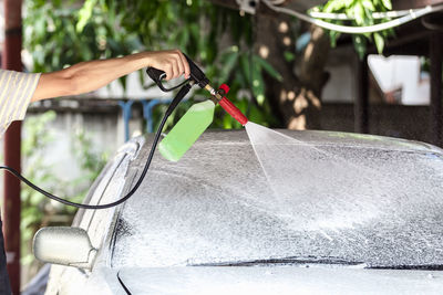 Low section of man washing car