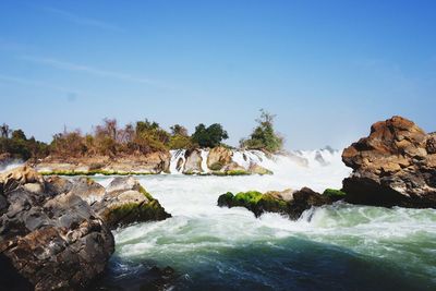 Scenic view of waterfall against clear sky