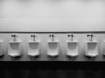 Urinals on wall in public restroom