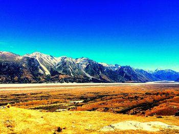 Scenic view of mountains against blue sky