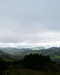 Scenic view of mountains against cloudy sky