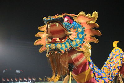 Low angle view of multi colored statue on illuminated street