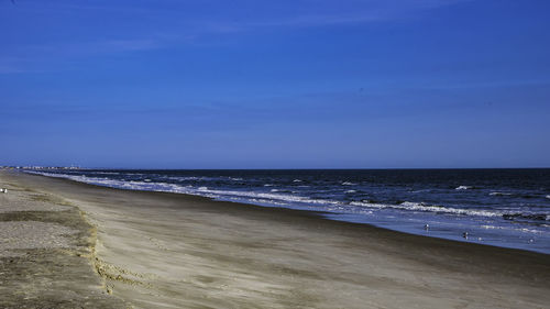 View of beach against blue sky