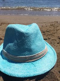 High angle view of blue hat on beach
