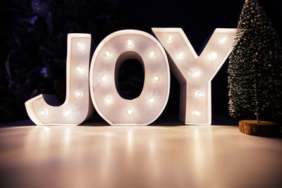 Close-up of illuminated christmas decorations on table