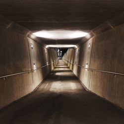 Empty corridor in illuminated building
