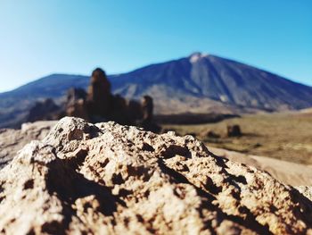 Scenic view of rocky mountains against clear blue sky