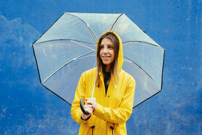 Portrait of young woman holding umbrella