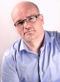 Portrait of man wearing eyeglasses against white background