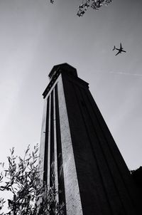 Low angle view of airplane flying against sky