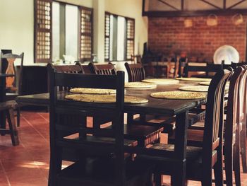 Empty chairs and tables in restaurant