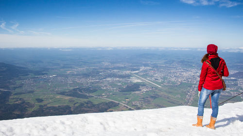 Rear view of man on snow covered landscape