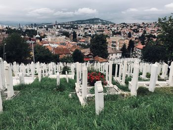 Panoramic view of cemetery and buildings against sky