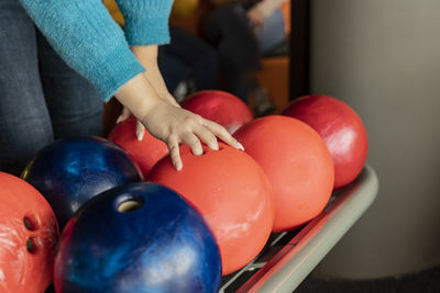 Hand of woman lifting bowling ball